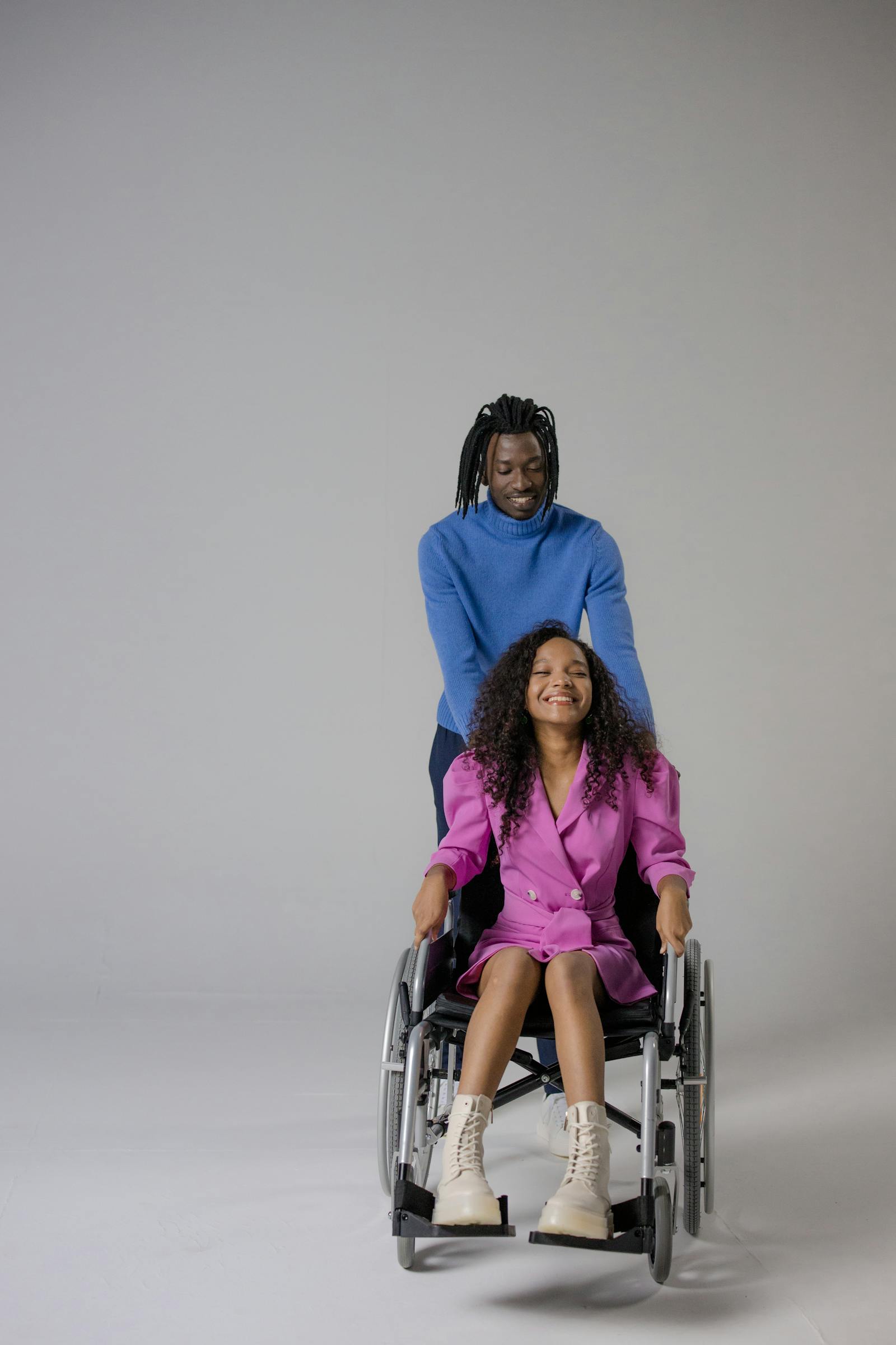 Two adults in their 20s to 40s smiling together, reflecting confident support and inclusive care